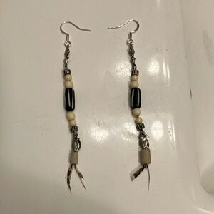Bone beads with silver accents and hangers with feathers dangling earrings.